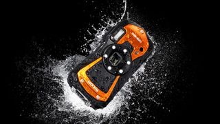 Ricoh WG-80 waterproof camera splashing in water with a plain black background