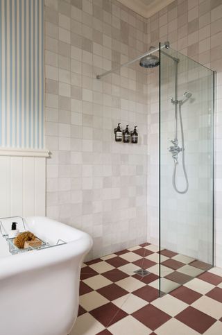 a bathroom with a checkerboard tile shower floor