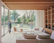 views of Panoramic House by Mata with a timber clad extension and built in furniture