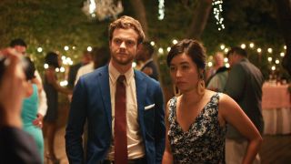 Maya Erskine and Jack Quaid getting picture taken at a wedding in Plus One