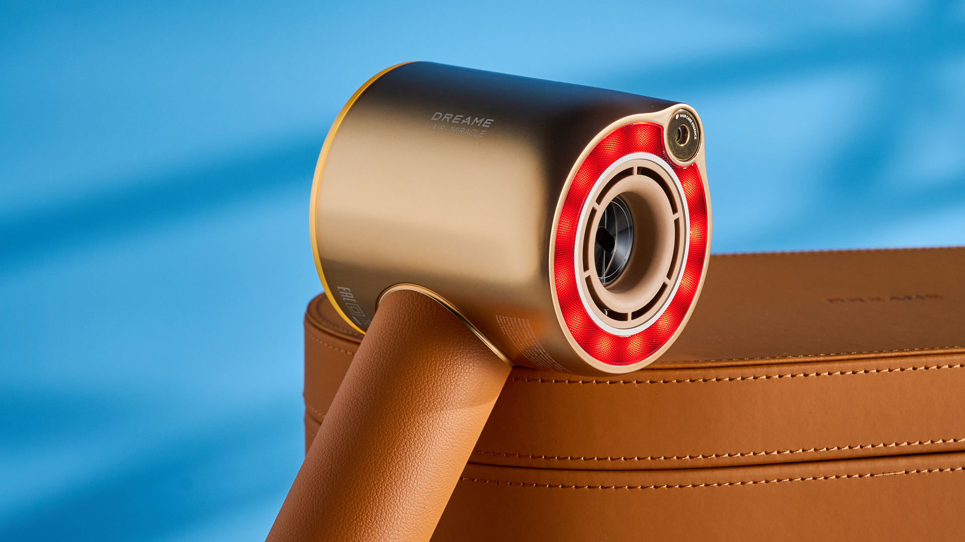 the dreame miracle pro hair dryer in gold showing the storage box on the blue tom's guide background, with the four attachment nozzles including two blow-drying nozzles, diffuser, and the flyaway tamer