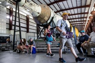 Russ Bailey walks past the command module of the Saturn V rocket in Rocket Park during the 50th anniversary celebration of the Apollo 11 moon landing at Space Center Houston on Saturday, July 20, 2019, in Houston.