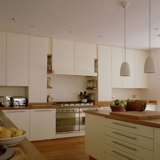 sleek kitchen with kitchen cabinet and hanging lights