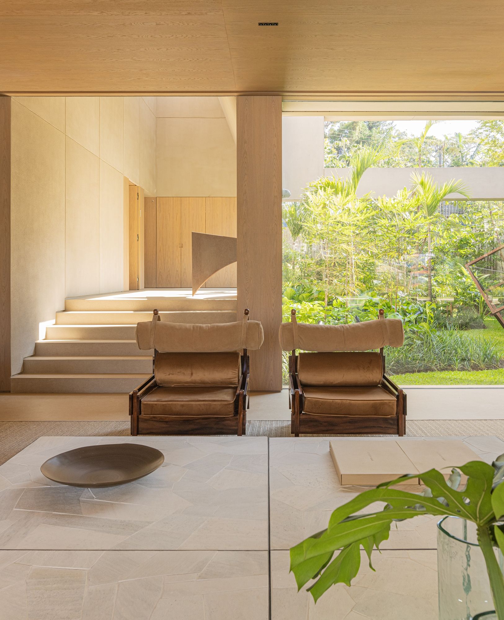 Pacaembu House armchairs placed next to staircase