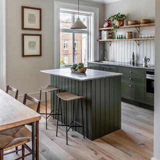 kitchen with white wall grey cabinet wooden shelf and chairs