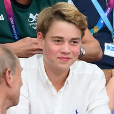 Prince George smiling in a white shirt