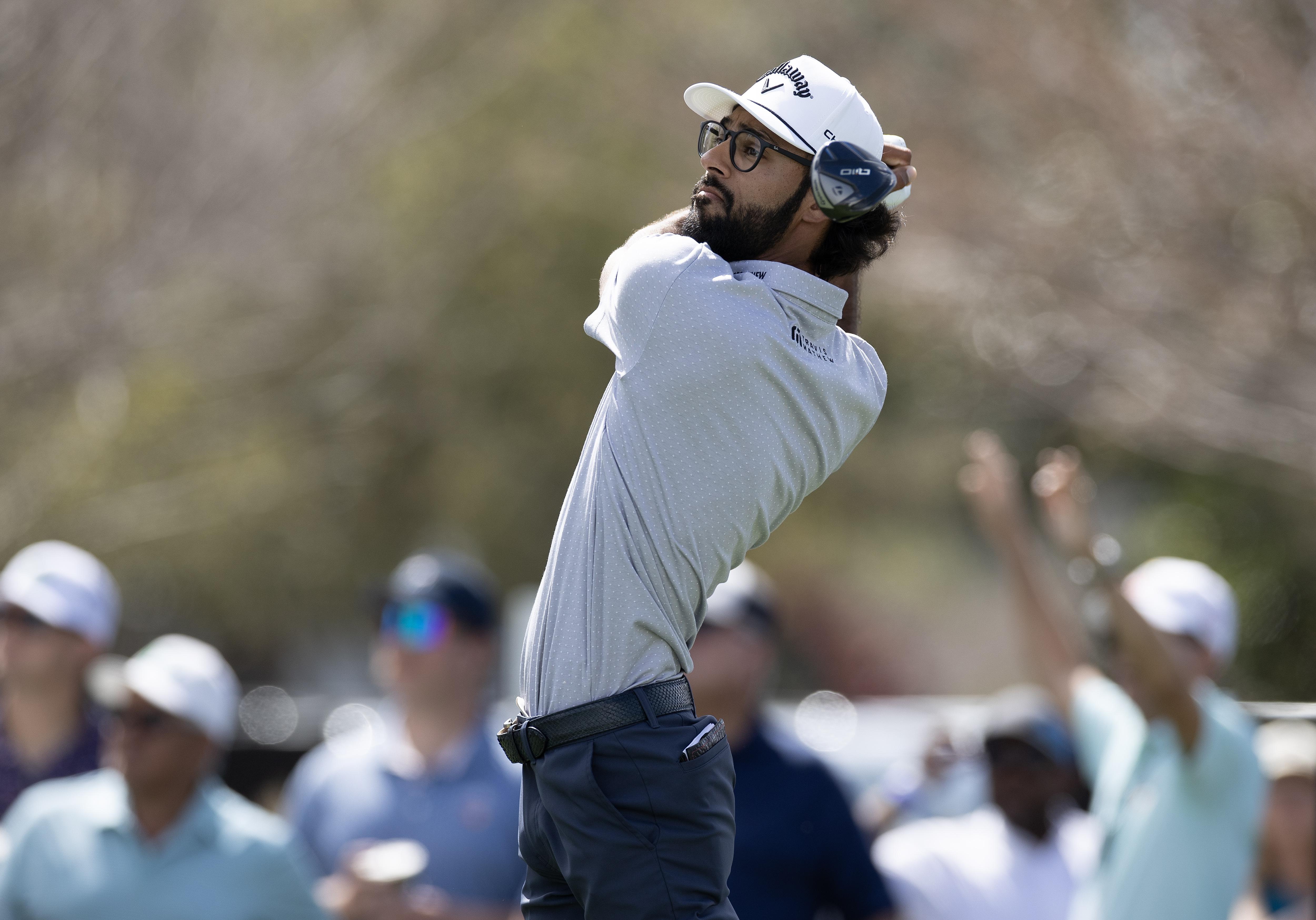 Akshay Bhatia hits a fairway wood