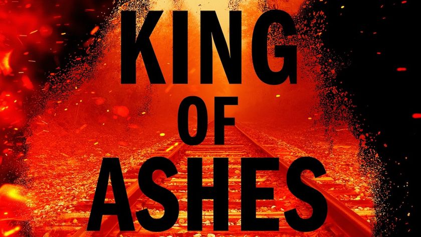 King of Ashes text from book cover over a red-tinted image of train tracks. 