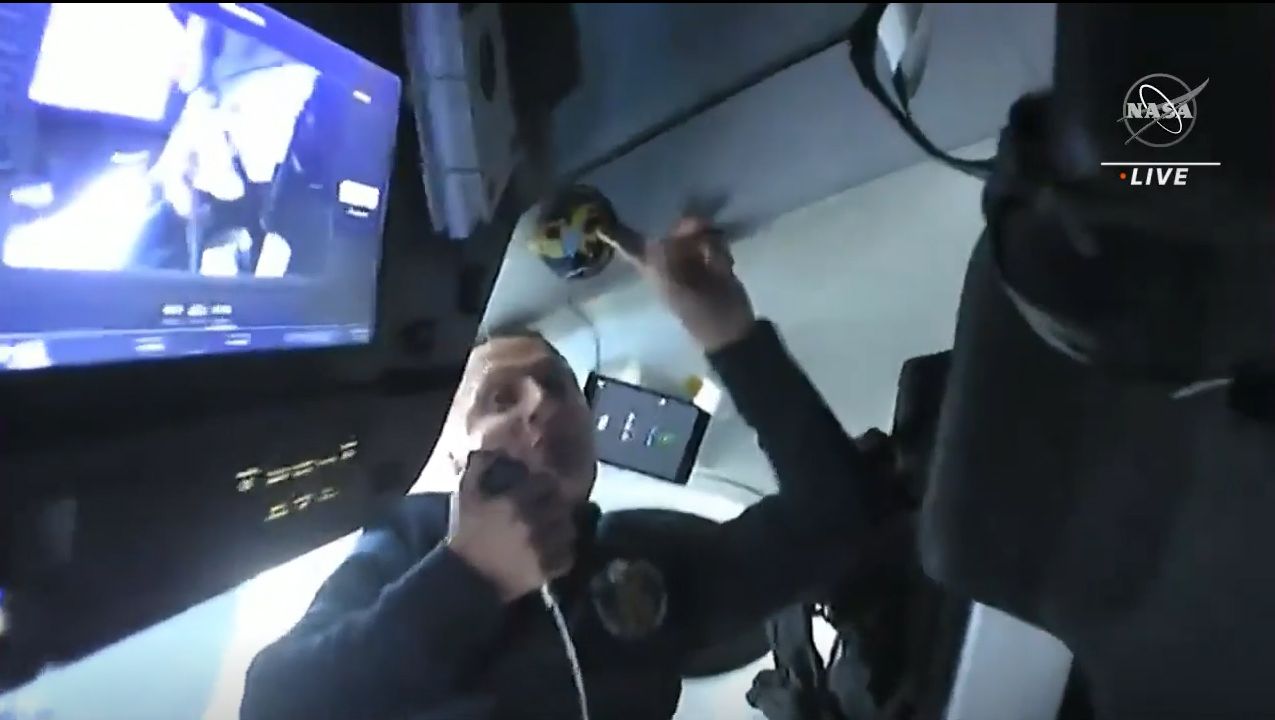 European Space Agency astronaut Matthias Maurer points out the Crew-3 mission patch he and his crewmates placed inside the Crew Dragon Endurance to mark their trip to the International Space Station.