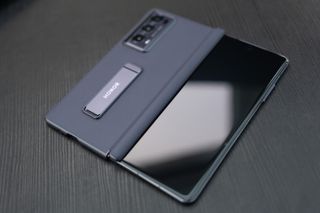 An Honor Magic V2 foldable phone sitting on a desk