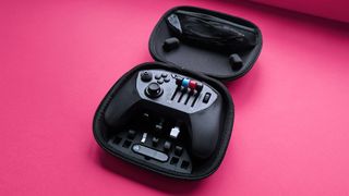 Honeycomb Aeornautical Echo Aviation Controller with a magenta cardstock background highlighting its open carry case with accessories