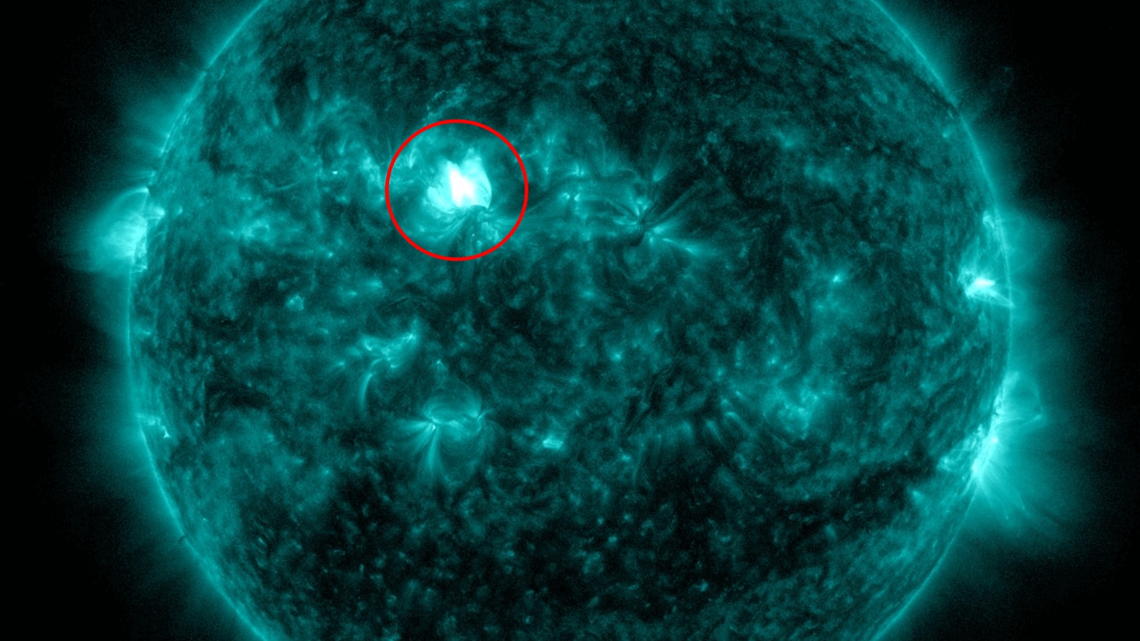 A photo of the sun with a bright flash of a solar flare on its surface