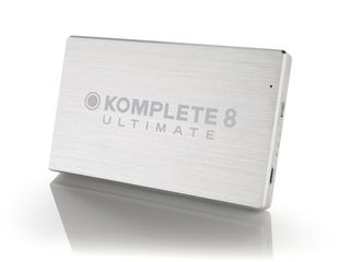 Komplete 8 Ultimate's files are installed from a shiny silver USB drive.