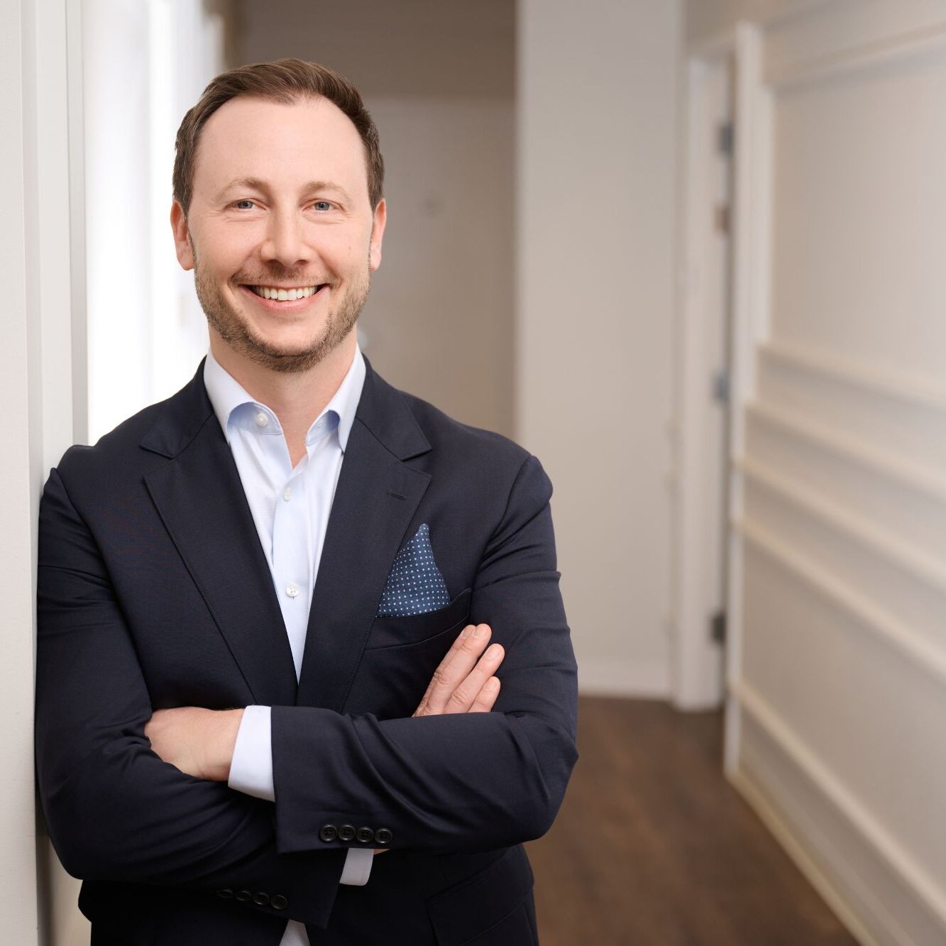 a white man in a navy suit and white shirt