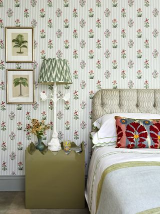 Quirky bedroom with patterned Dado Atelier wallpaper, headboard and cushions