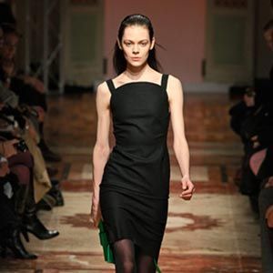 Woman in black dress on catwalk