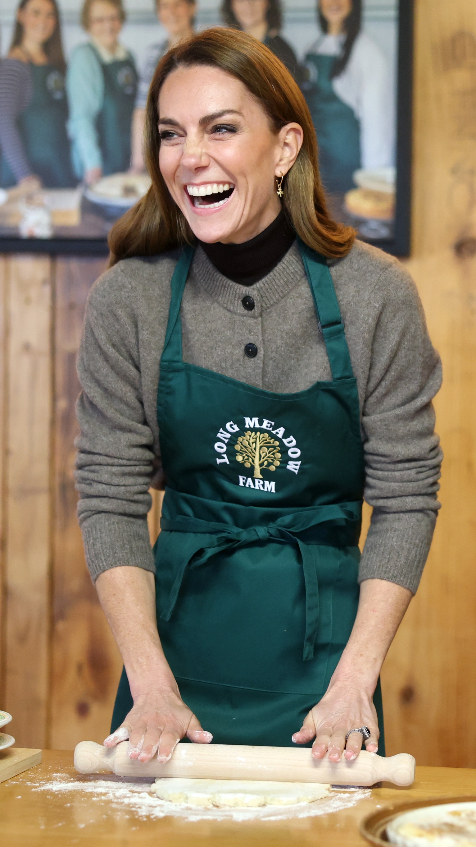 Catherine, Princess of Wales laughs as she makes a potato and apple cake during a visit to Long Meadow Cider on October 14, 2025 in Craigavon