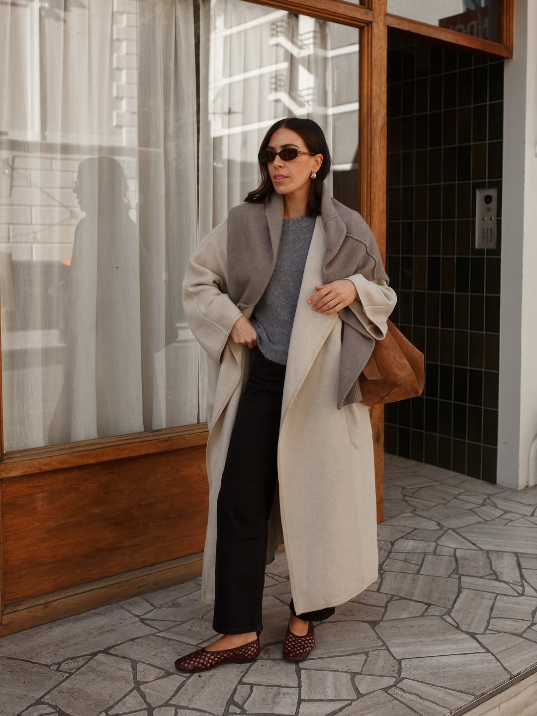 Influencer Jessica Skye wearing a wool coat and black jeans.