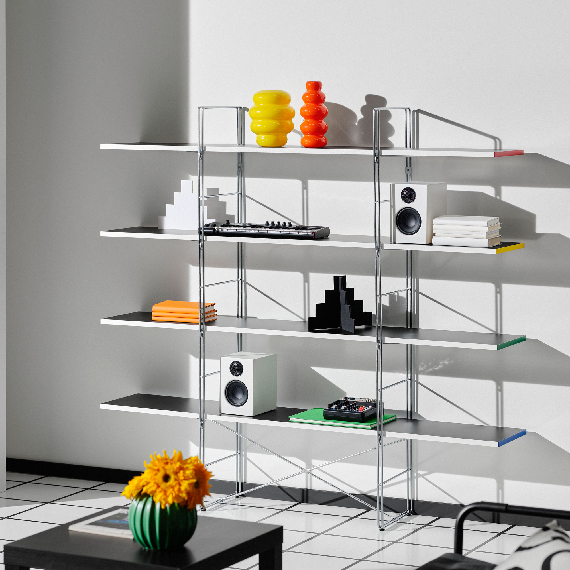 IKEA open shelving with coloured edges and metal frame in a white room