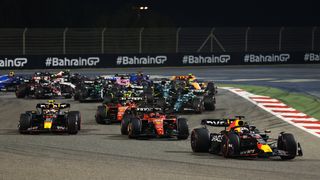 ax Verstappen of the Netherlands driving the Red Bull Racing F1 car leads Charles Leclerc and the rest of the field at the start during the F1 Bahrain Grand Prix at Bahrain International Circuit