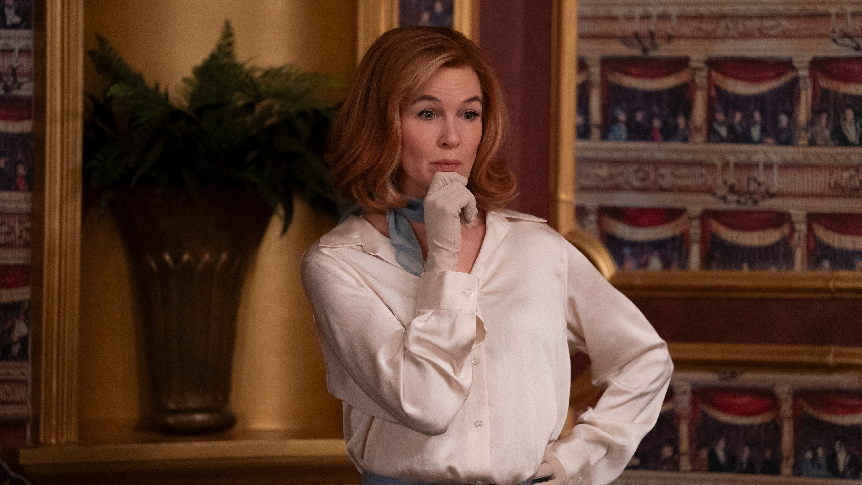 Ren&amp;eacute;e Zellweger in a pale blouse and gloves as Camila White in Only Murders in the Building