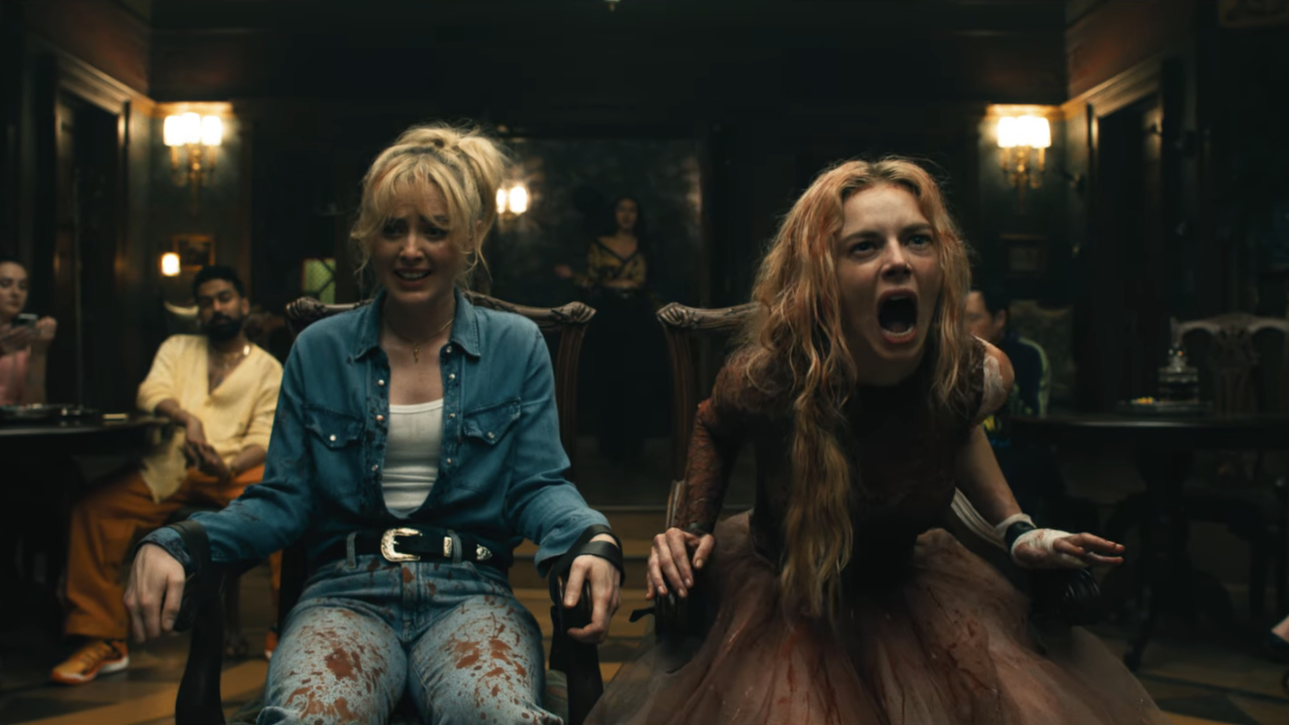 katherine newton and samara weaving screaming while tied to chairs as other people stare at them in a still from ready or not 2 here i come