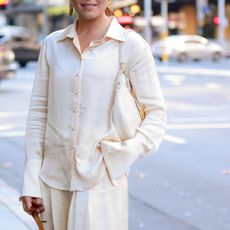 Woman in white silk shirt GettyImages-1490526363