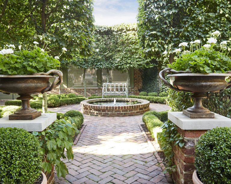 water feature ideas: A garden with circular water fountain at the centre of symmetrical formal garden layout, with classical style urns
