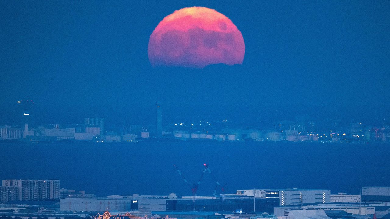 The full moon is seen from the observation deck of Roppongi Hills Mori Tower, during a harvest-moon viewing event in Tokyo on September 10, 2022.