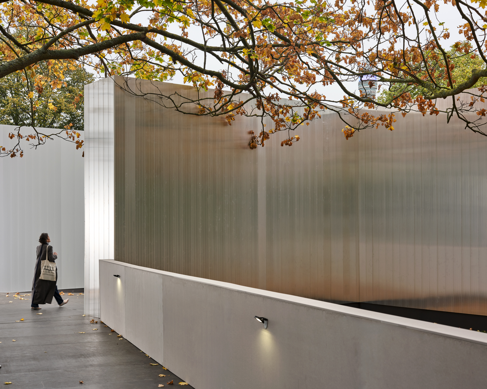 Frieze entrance pavilions exterior in London 2025 seen in golden light and fallen autumn leaves