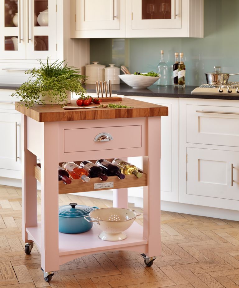 Small pink kitchen island one wheels with wine storage and wooden top