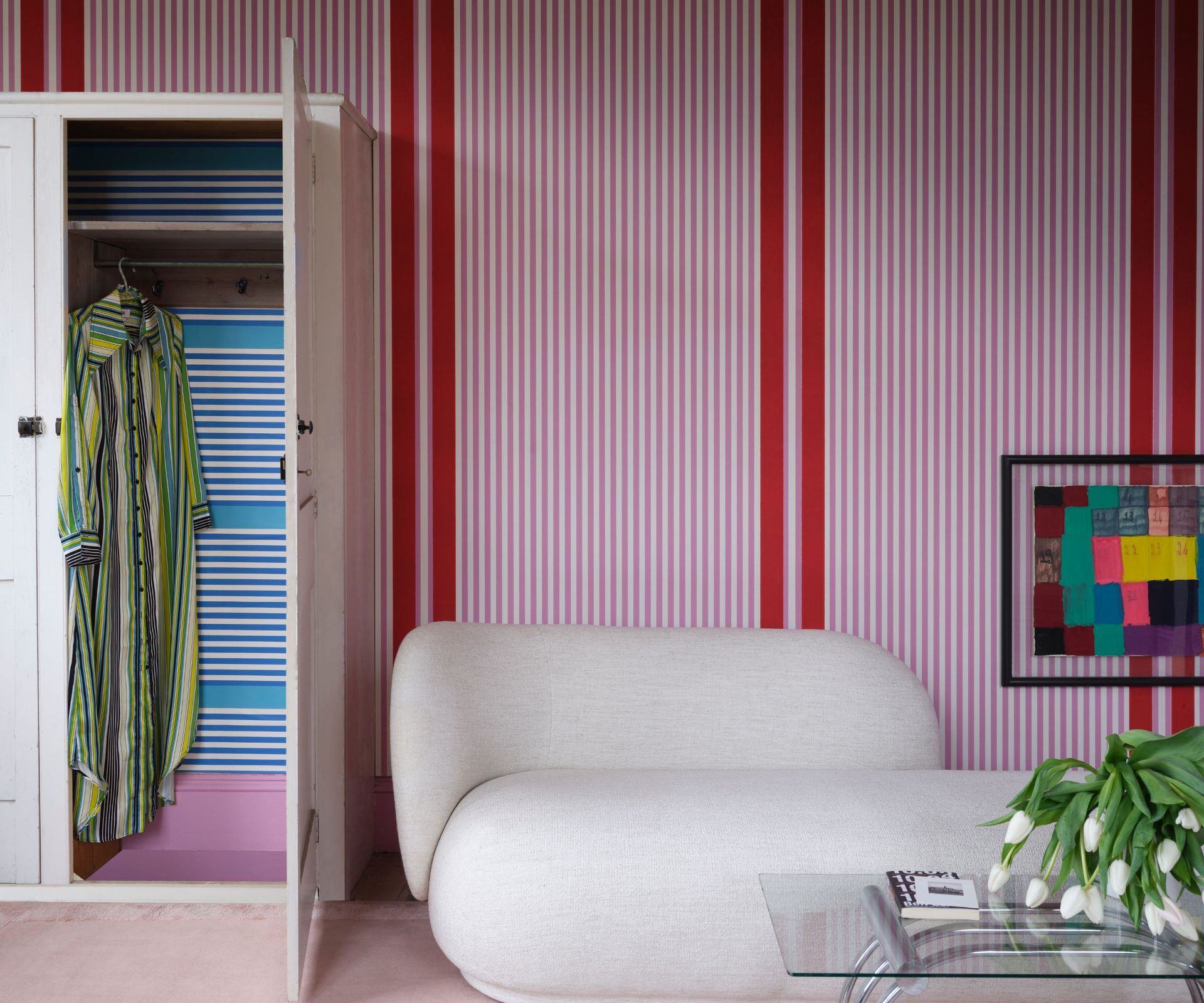 Pink and red striped wallpaper and blue striped wardrobe