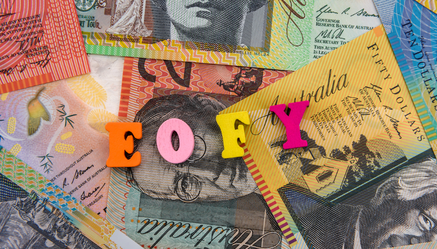 Letter blocks of E, O, F and Y on a stack of currency notes