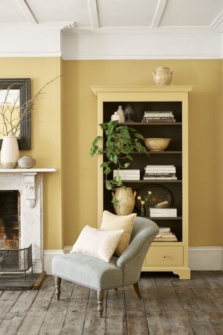 yellow living room with alcove and book case painted yellow as are the walls