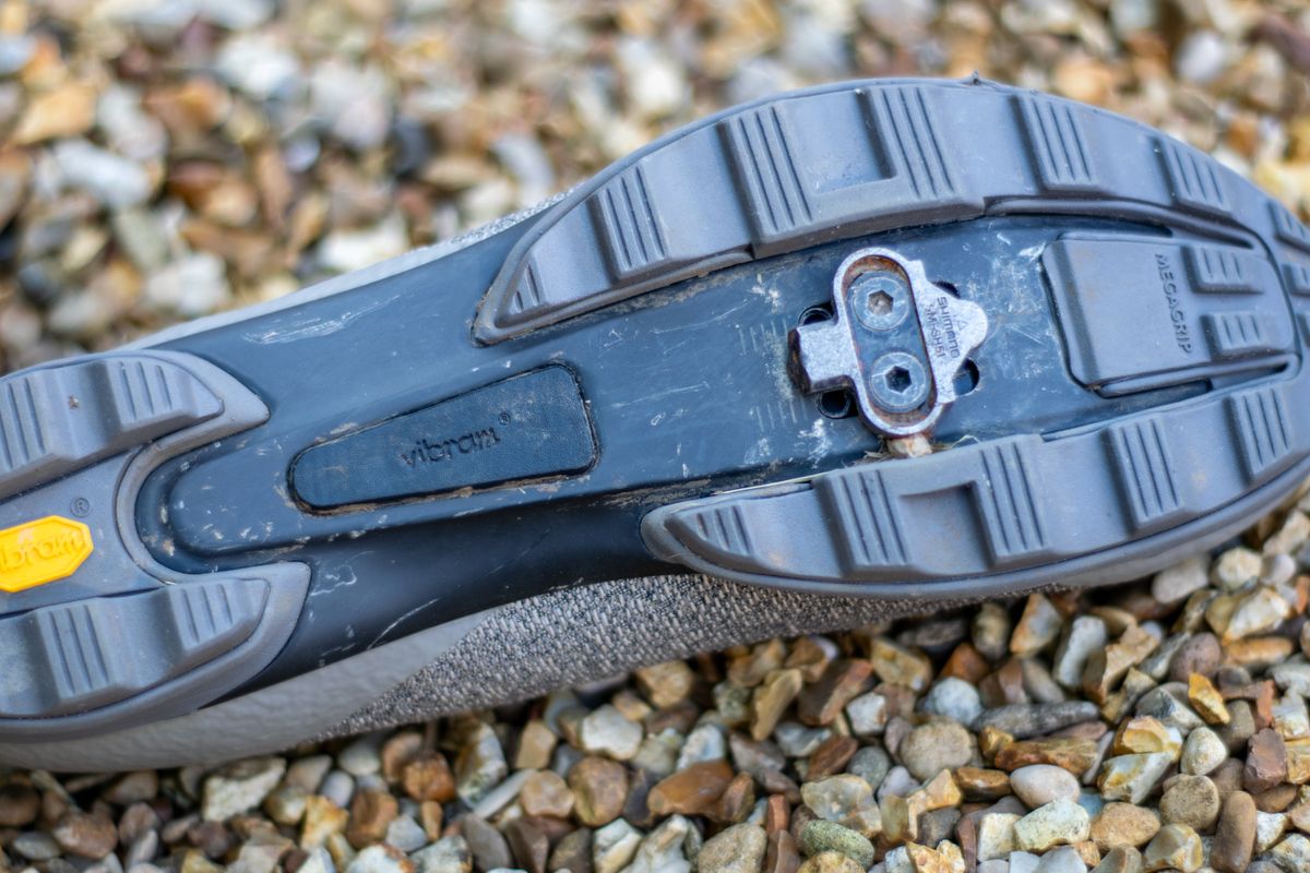 A Rapha Pro Team Gravel shoe on some gravel