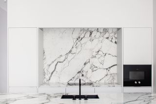 black sink in white marble kitchen