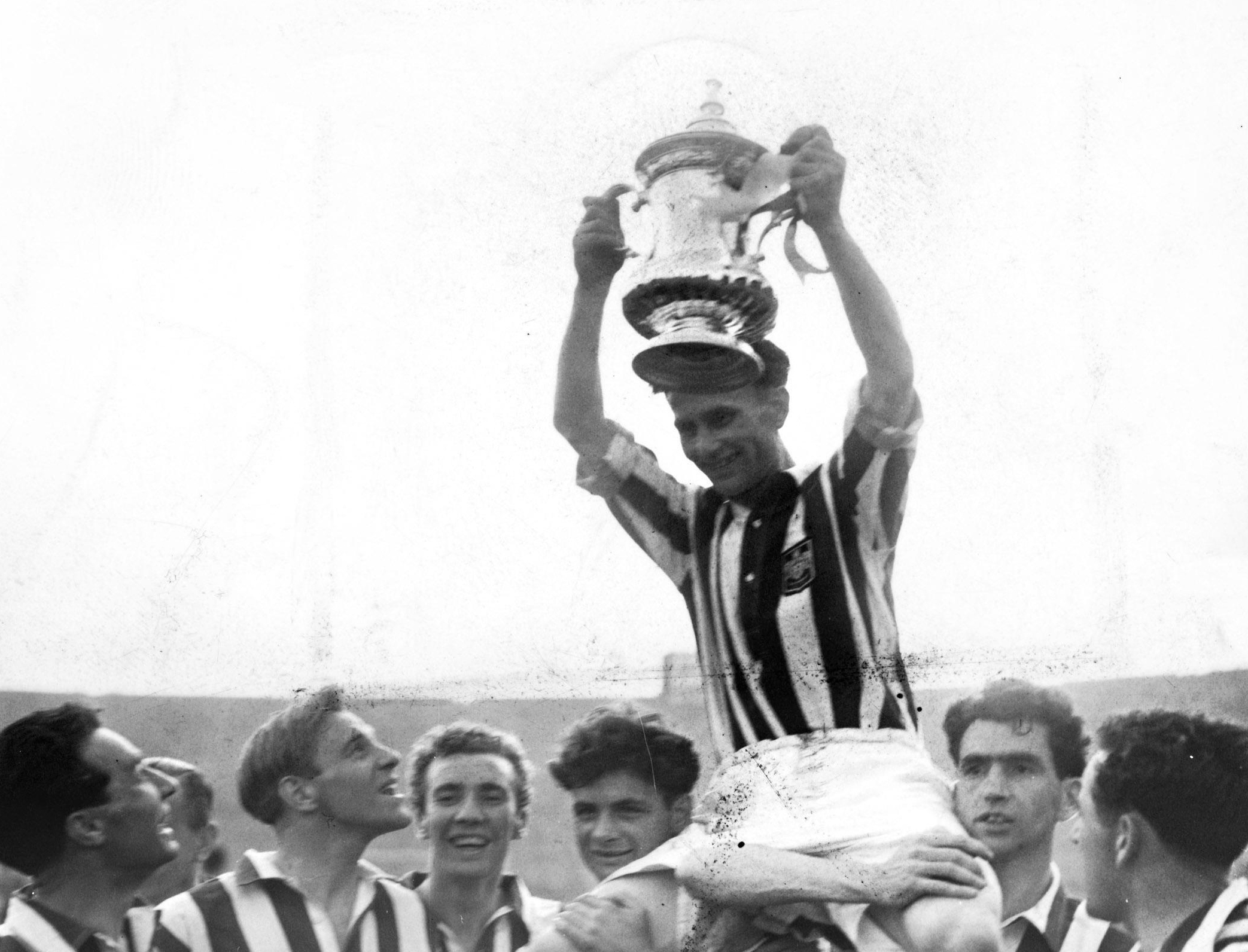 West Brom captain Len Millard lifts the FA Cup after victory over Preston North End in the 1948 final at Wembley