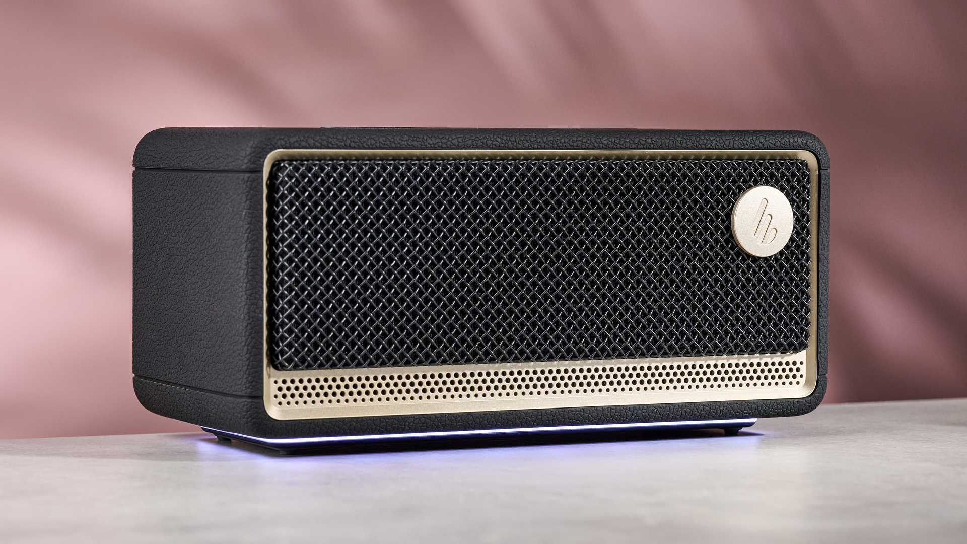 Edifier ES60 on table, against pink background with lights active