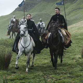 Woman on white horse and man on black horse in green fields followed by men in full armor