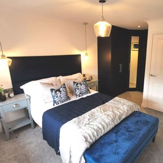 guest bedroom with wardrobe and bedside table and lamps