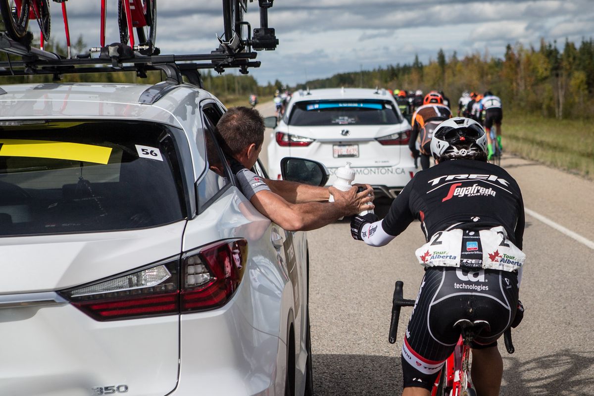 Julian Arredondo (Trek) gets a handup from the team car during stage 3 in Alberta