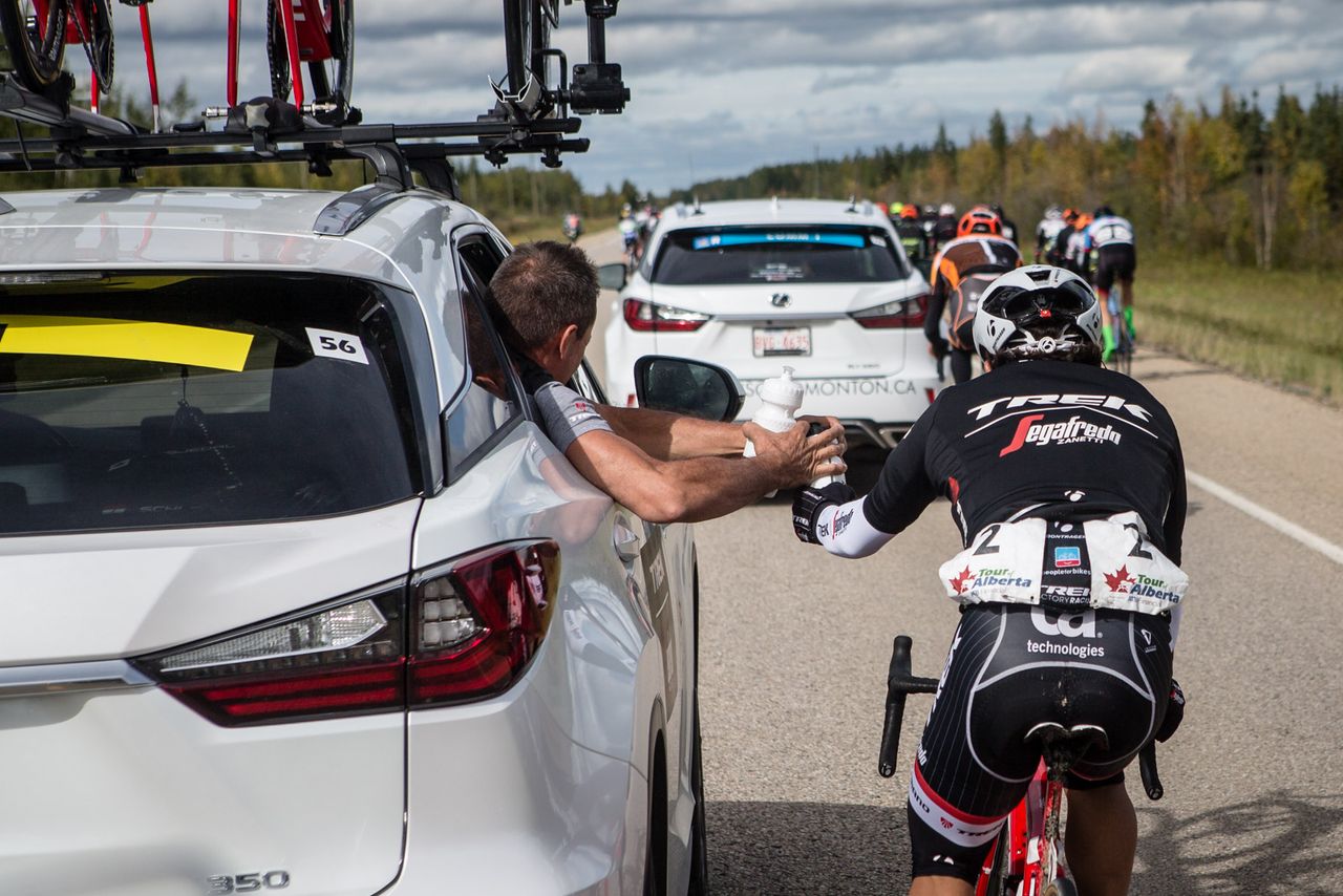Julian Arredondo (Trek) gets a handup from the team car during stage 3 in Alberta