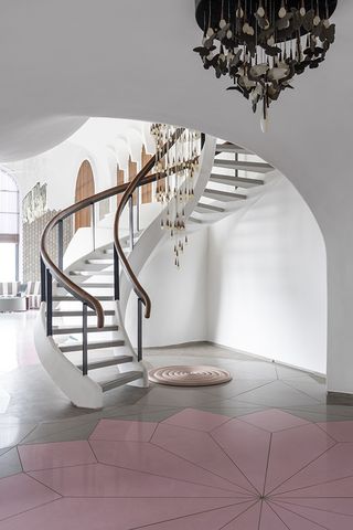 curving staircase in cavernous kolkata home interior