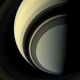 The spectacular rings of Saturn cast dark shadows on the ringed planet as the winter season approaches in Saturn's southern hemisphere in this view from the Cassini spacecraft. 