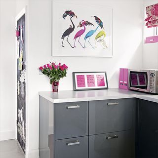 living room with glossy grey cabinet white walls photo frame on wall and flower vase