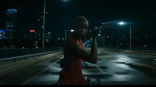 Okoye raises her spear to fight the Talokanil in Black Panther: Wakanda Forever