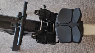 The Aviron Strong Series Rower, a close-up photo of the seat and footplates