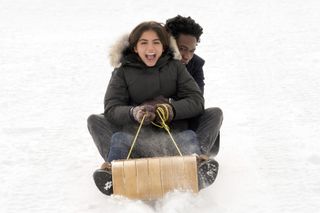 two teenagers sledding in the movie 'Let It Snow'