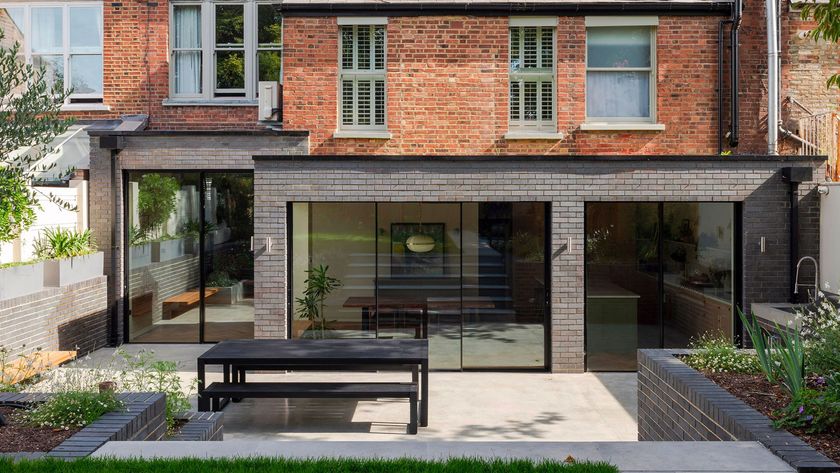 blue brick L-shaped extension with sliding doors