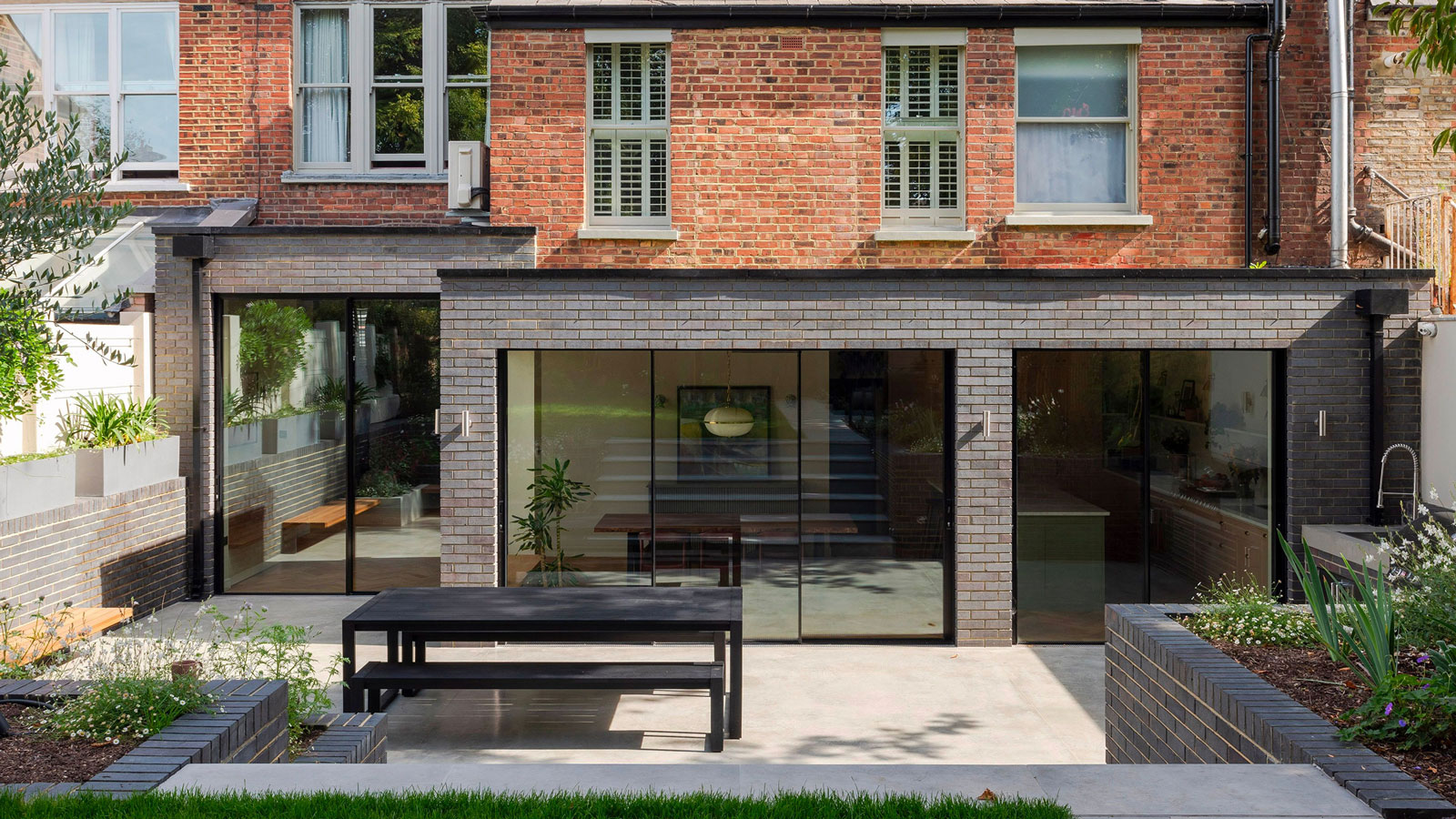 blue brick L-shaped extension with sliding doors
